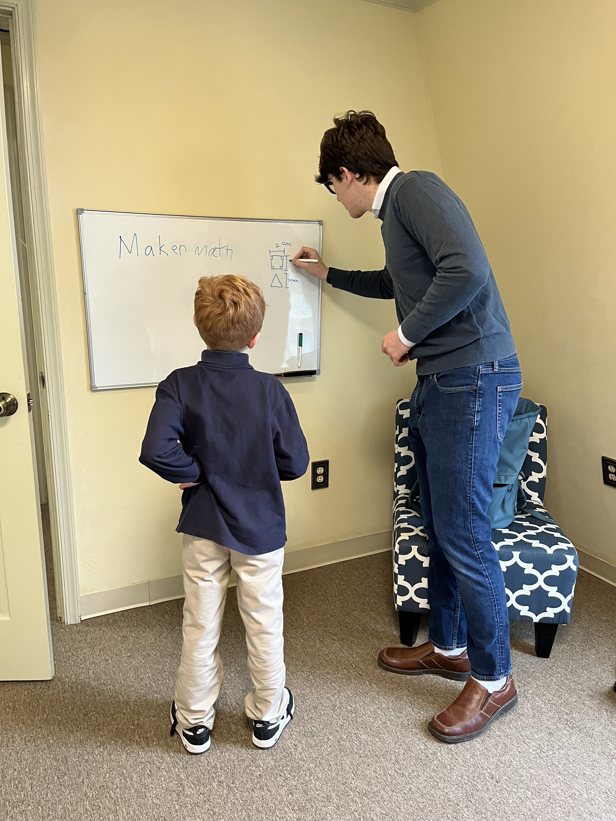 Parker Doerr teaching a student at Maker Math.
