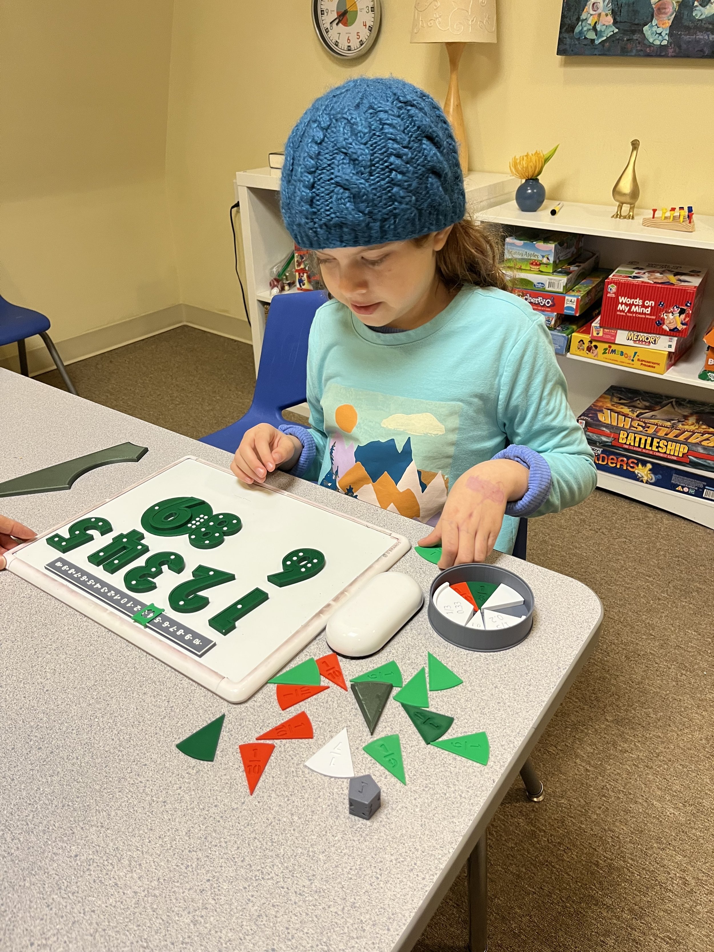 A student works with 3D printed math manipulatives at a Maker Math session.