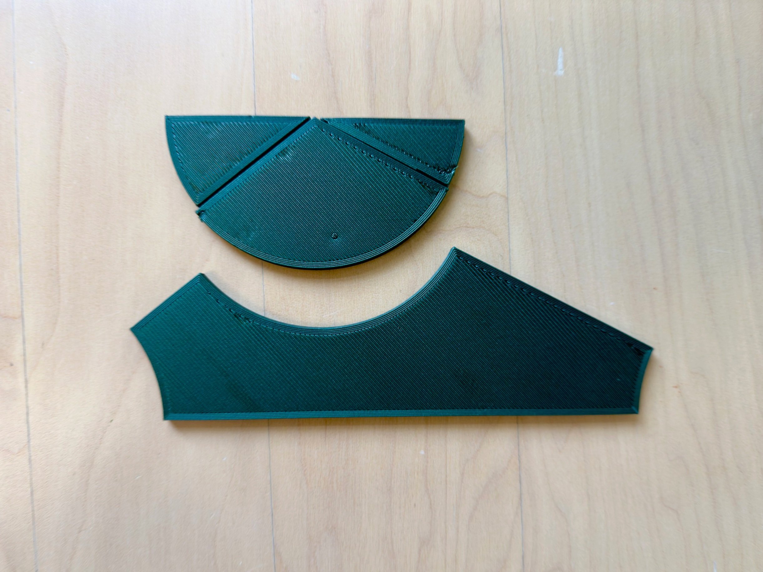 The same triangle manipulative disassembled, showing how the three angles form a straight line of 180 degrees - a hands-on proof of the angle sum theorem.